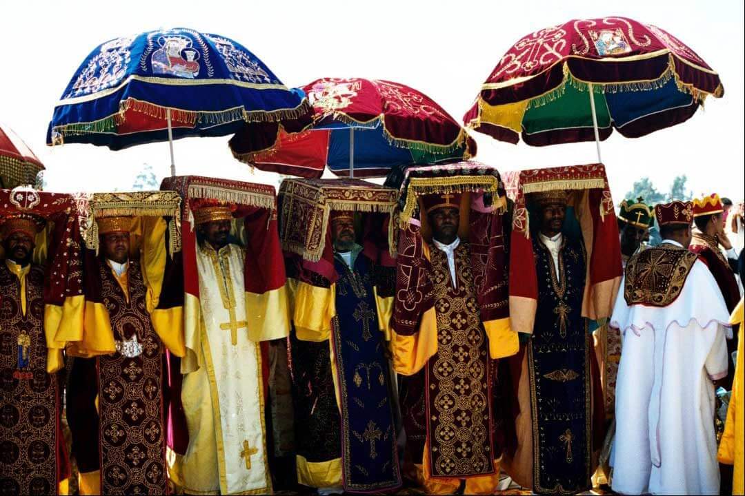 Priests carrying tabots under ceremonial umbrellas at Timkat